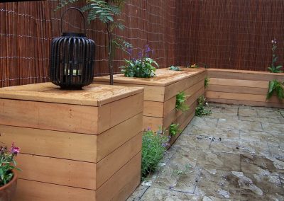 Cedar box seat in a small courtyard garden.