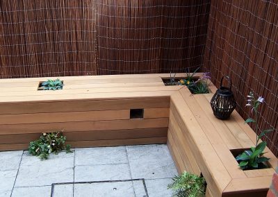 Cedar planter created to become garden seating and planted with ferns.