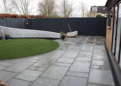 Circular lawn framed with blue brindle engineering bricks in our client's clothall common garden project.