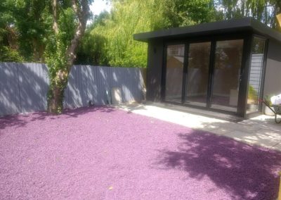 Plum coloured tyre chippings used as ground cover around the children's garden den.
