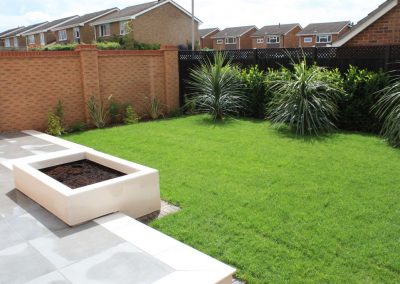 A langford garden design project with bespoke block planter diving the terrace and lawn in our Langford project.