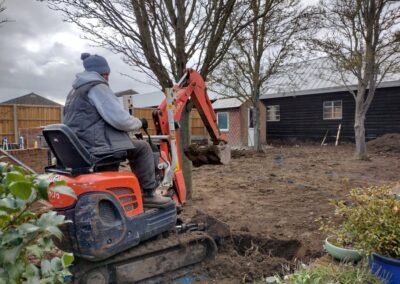 Landscaping team digging out the tree pits in our Bedfordshire garden project.