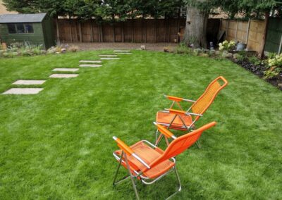 Orange garden chairs on the new lawn.